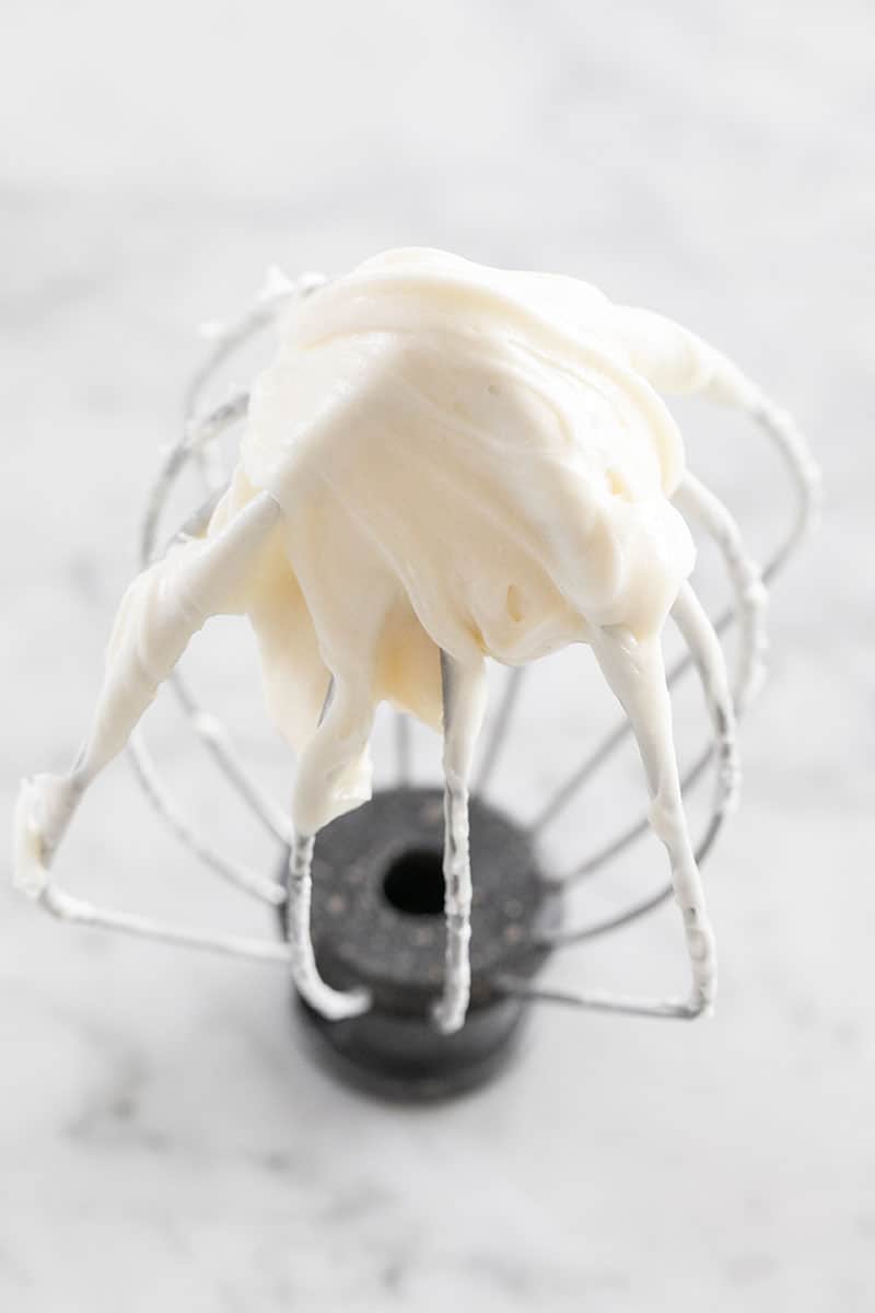 Cream cheese frosting on a whisk attachment.