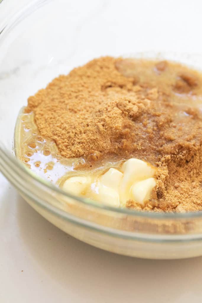 Butter, sugar, and Graham Crackers in a bowl.