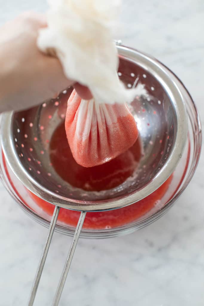 Straining watermelon juice.
