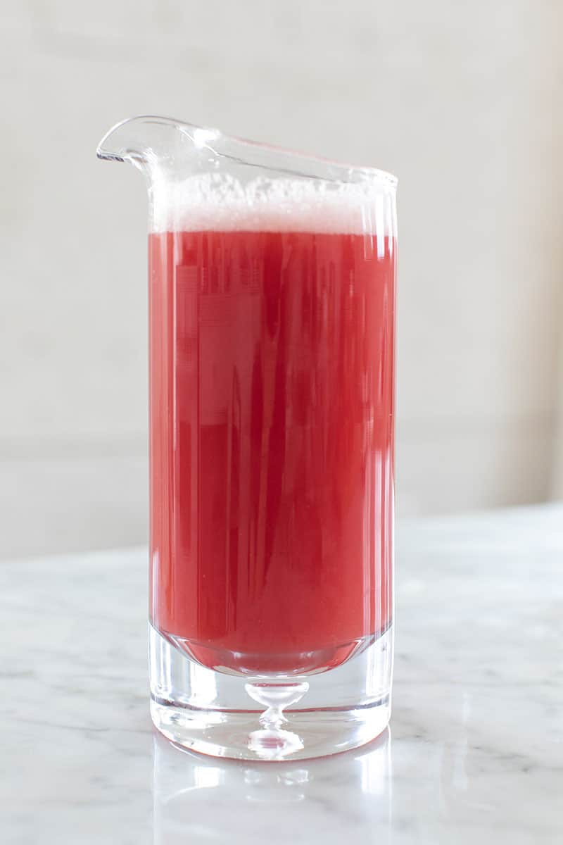 Watermelon juice in a glass pitcher.