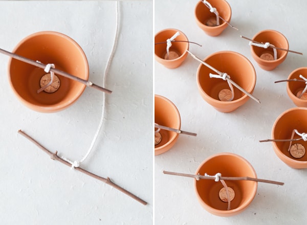 Terracotta planters with pennies and twigs 