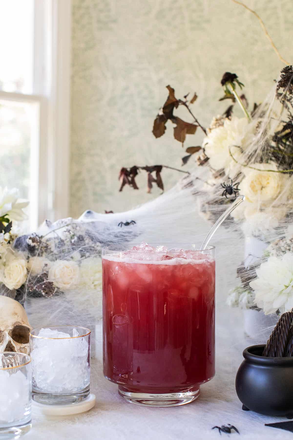 Halloween punch alcoholic in a large glass punch bowl.