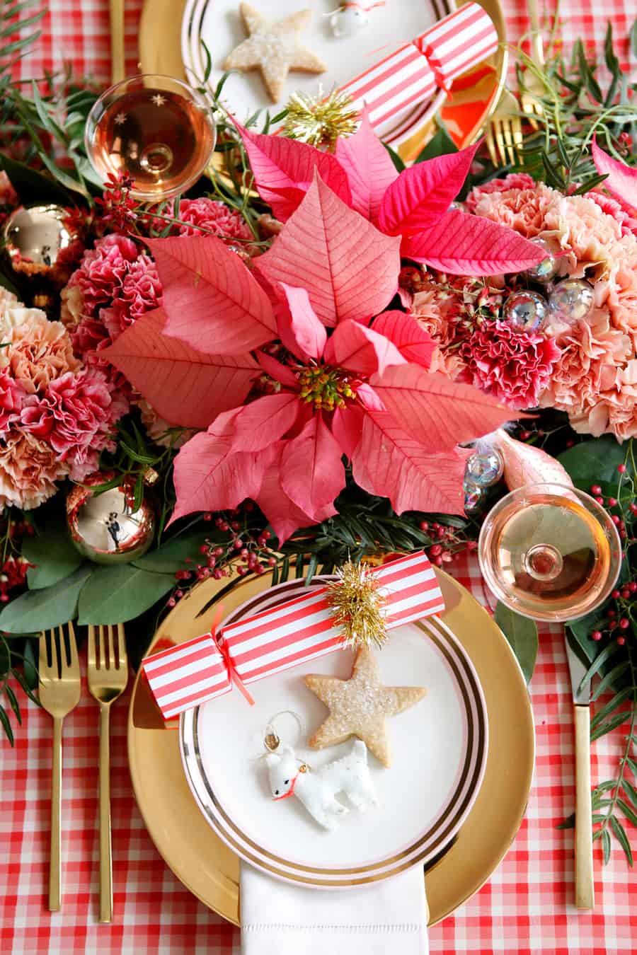 Christmas table setting with plaid table, flowers, cookies and ornaments 