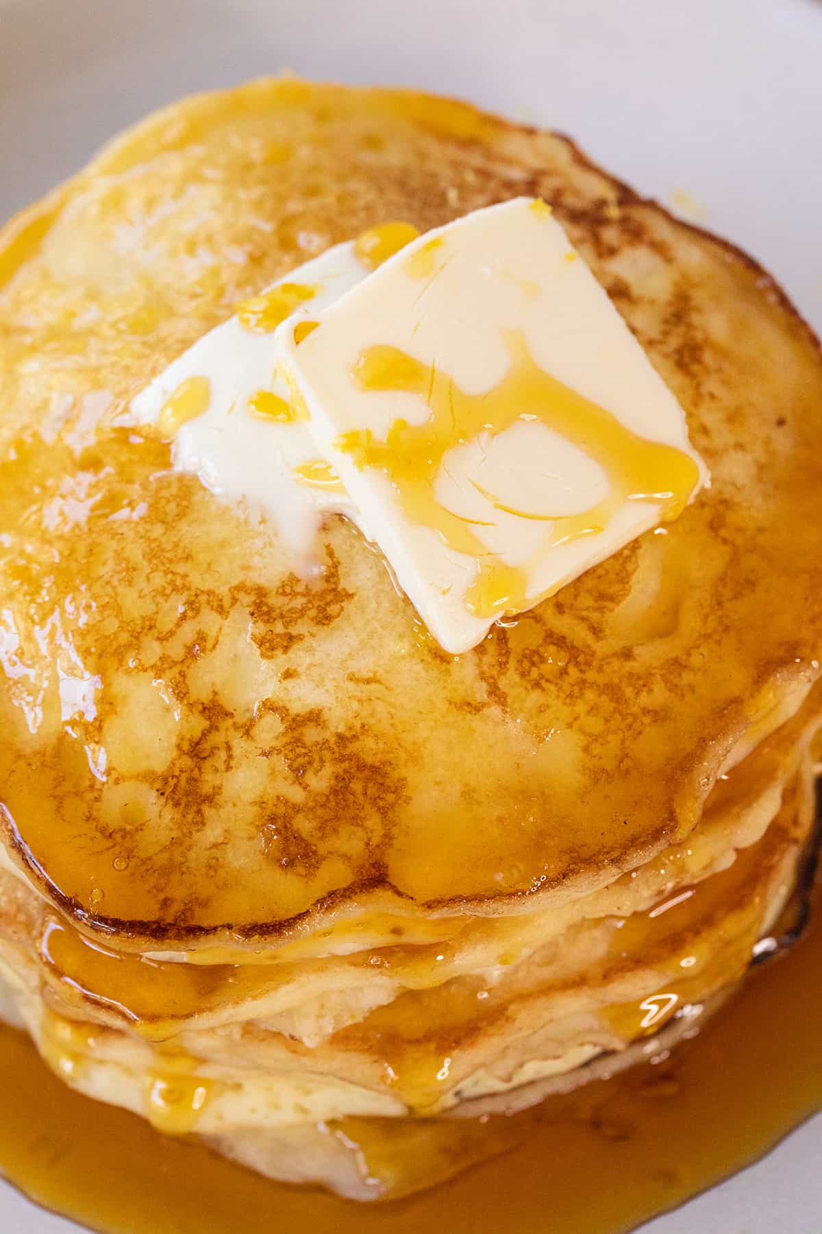 Lemon pancakes with butter and syrup.