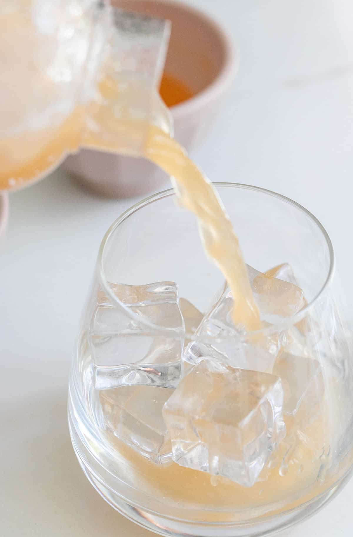 rum punch pouring into cocktail glass