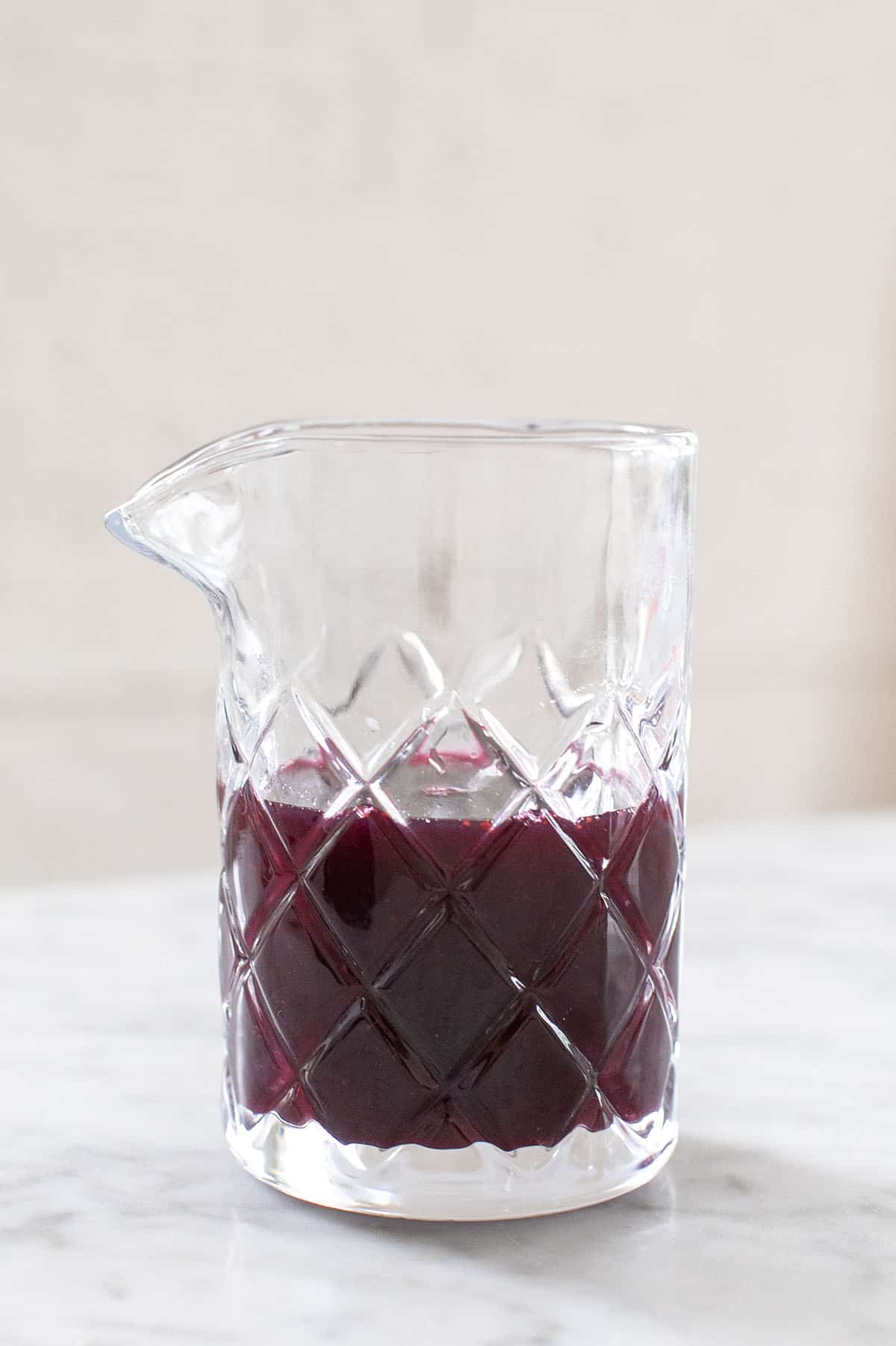 Blueberry simple syrup in a glass jar.