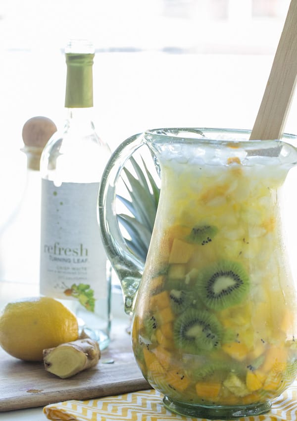 White wine sangria recipe in a pitcher with kiwi, pineapple and mango.