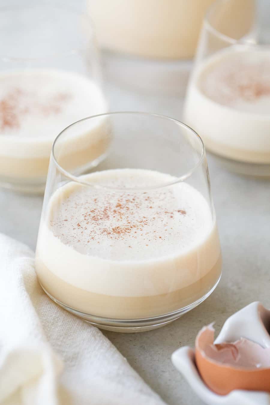 Spiked eggnog in a glass with bourbon and cinnamon. 