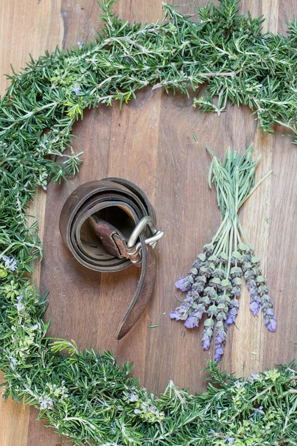 shot of materials for rustic rosemary wreath - rosemary wreath, rosemary sprigs, rosemary wreaths, green floral wire, both rosemary