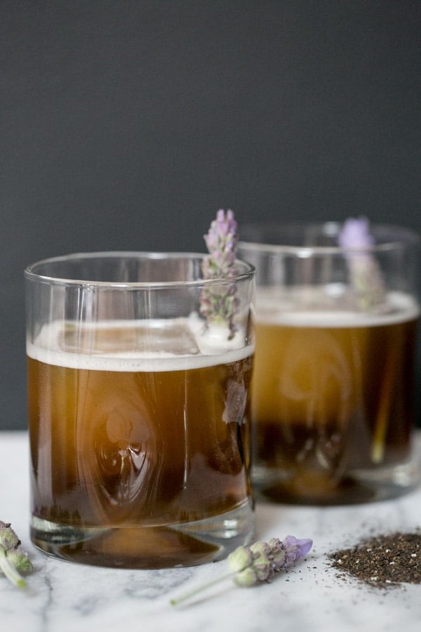 Two earl grey tea cocktails in glass tumblers.