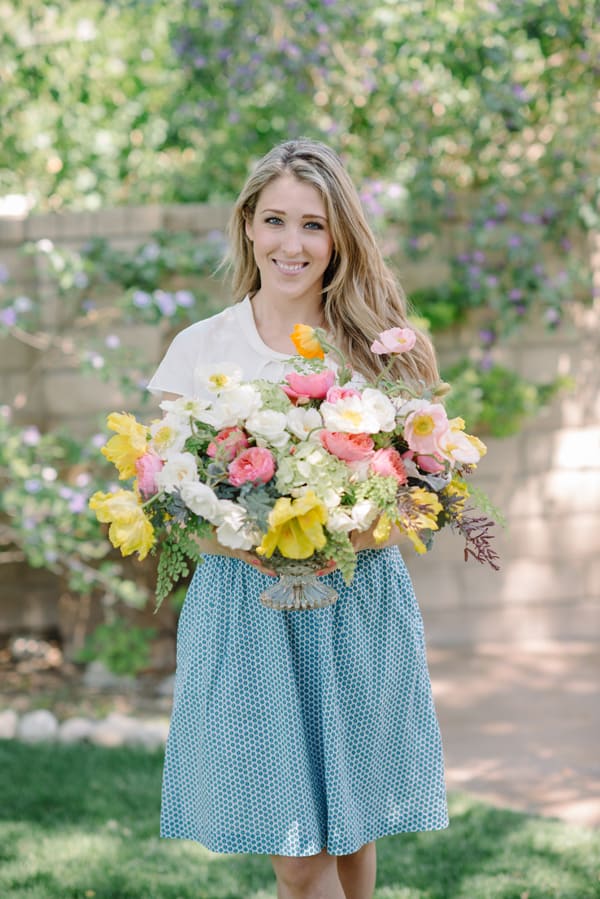 Eden Passante holding flowers in backyard. 