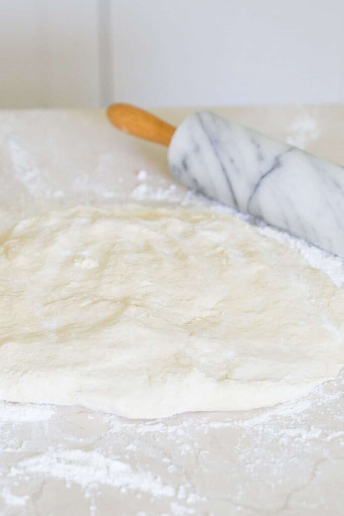 Rolling beignet dough.
