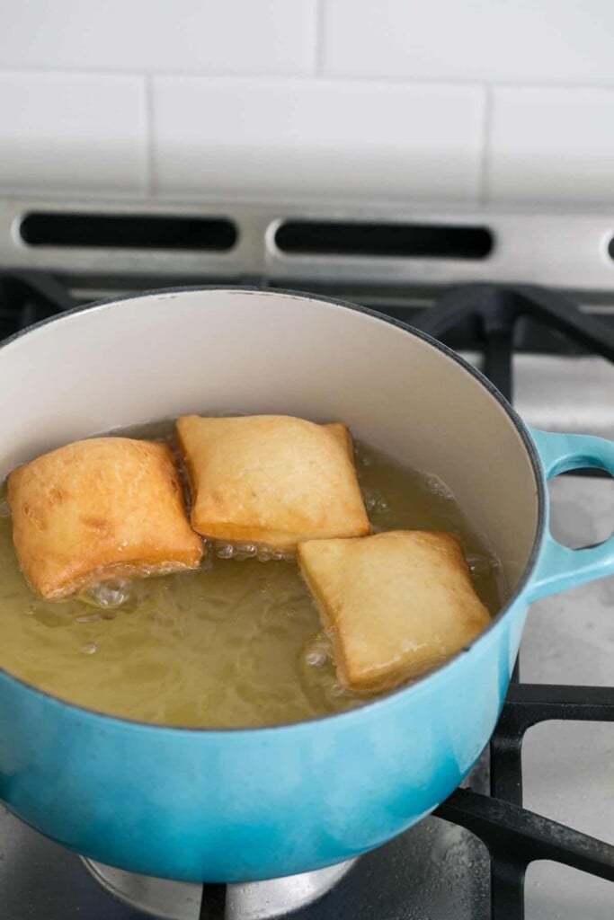Beignets cooking in oil.