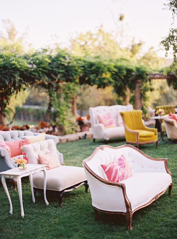 Couches and chairs on a lawn with tables