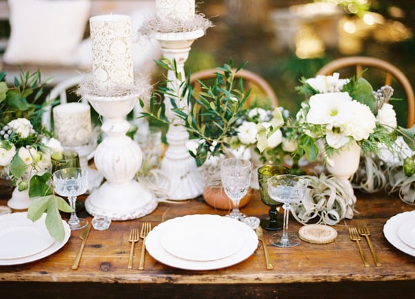 White wedding flowers on a wooden table and greenery