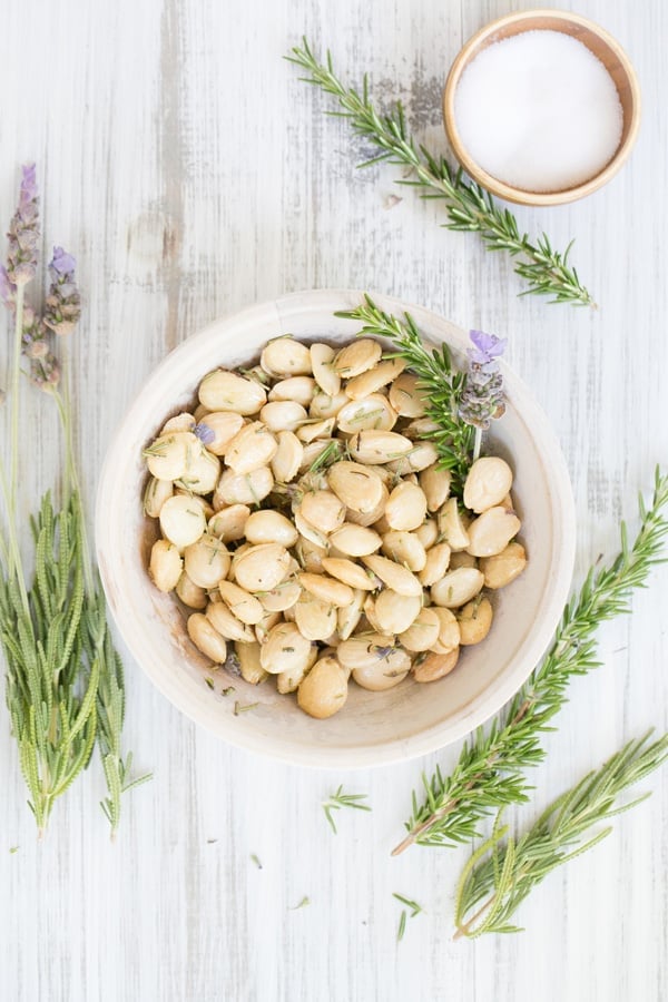 Marcona almonds with lavender and rosemary in a bowl.