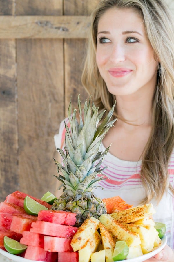 Eden Passante holding a Mexican style fruit plate.