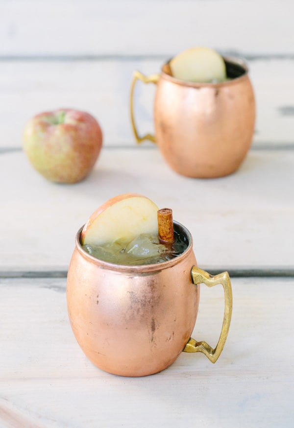 Two Apple Cider Moscow Mules in copper mugs.