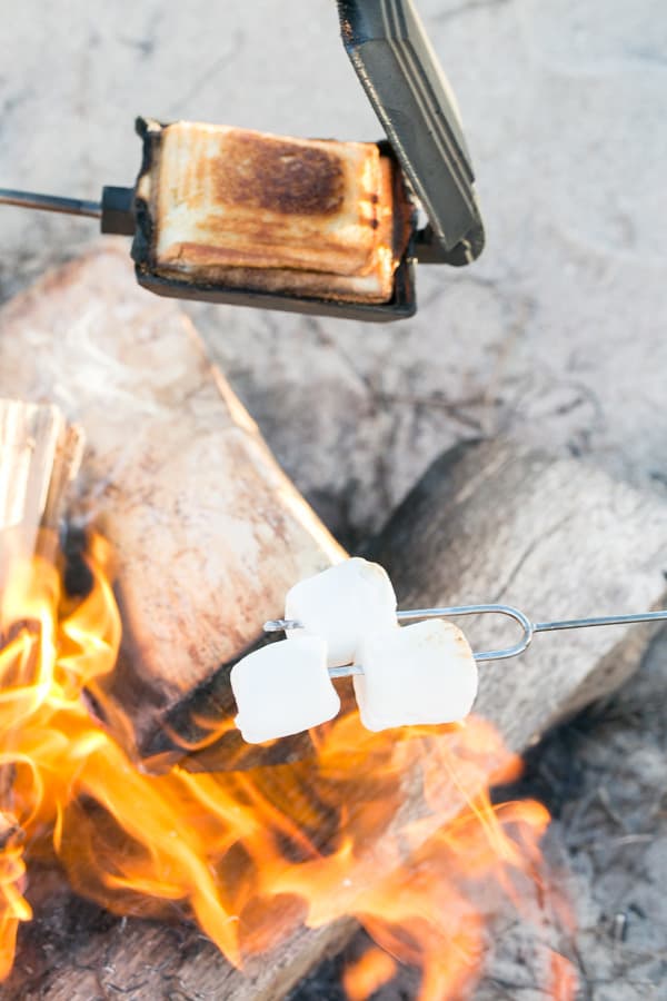 food being cooked on the beach bonfire