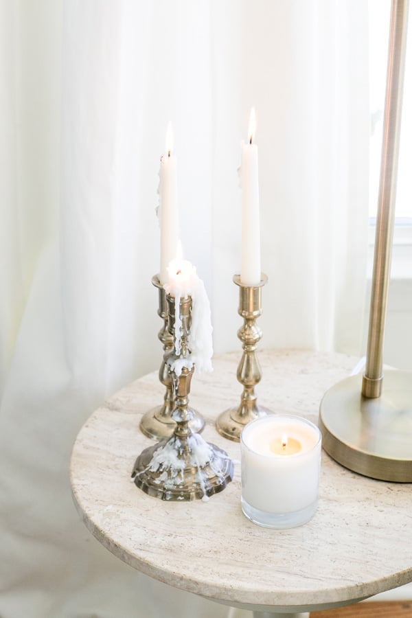 gold candle sticks on a marble table 