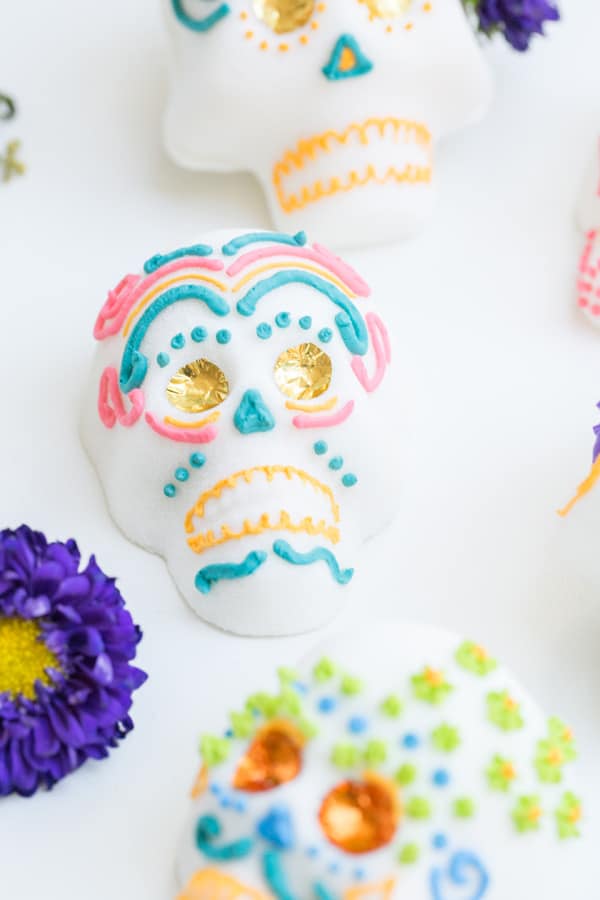 Mexican sugar skull with foil eyes and pink and blue frosting.