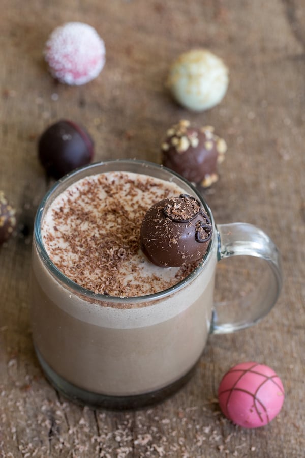 chocolate eggnog recipe in a mug with a Godiva chocolate over the top.