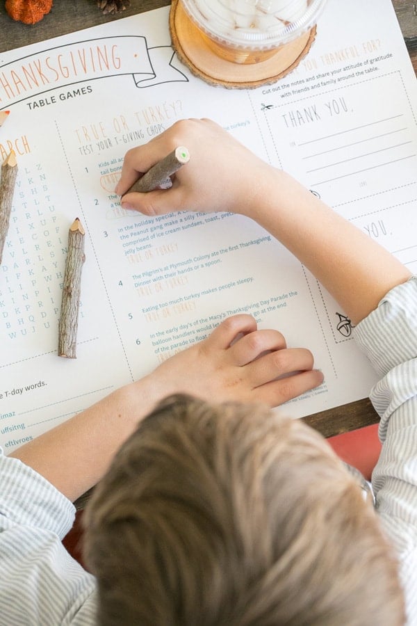 Kid working on a Thanksgiving word search.