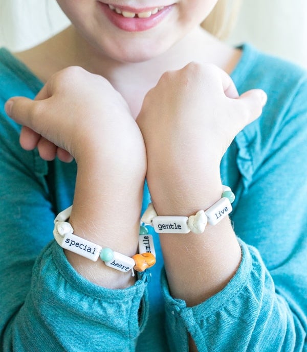 Little girl with DIY Thanksgiving bracelets.