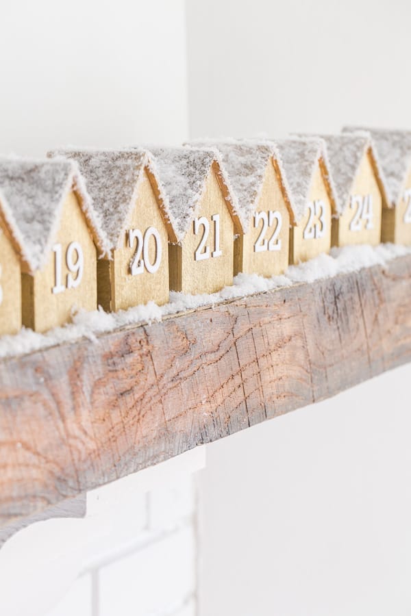 wooden houses lined up on the mantlepiece