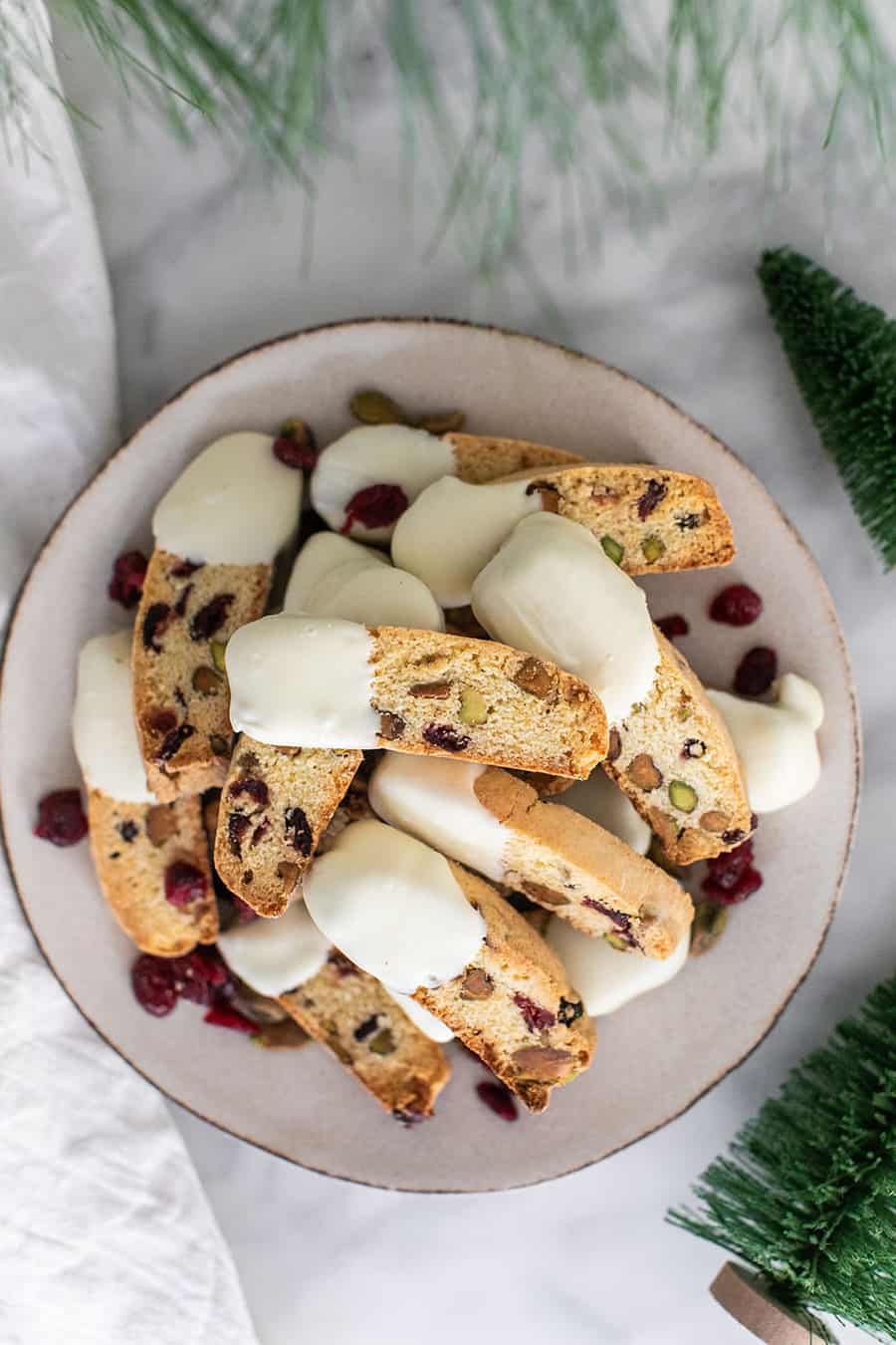 Biscotti cookies on a plate with cranberries and white chocolate