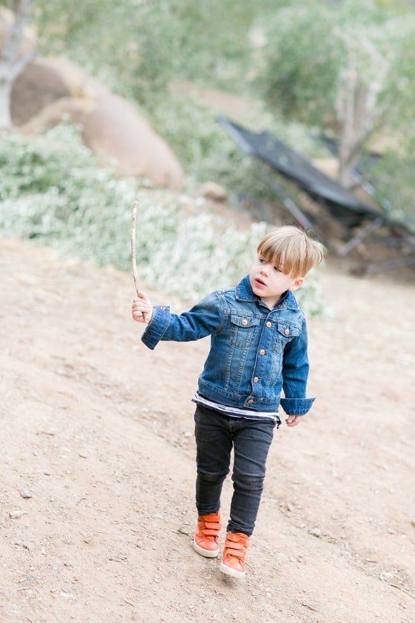 Little boy with orange boots waling in Ojai 