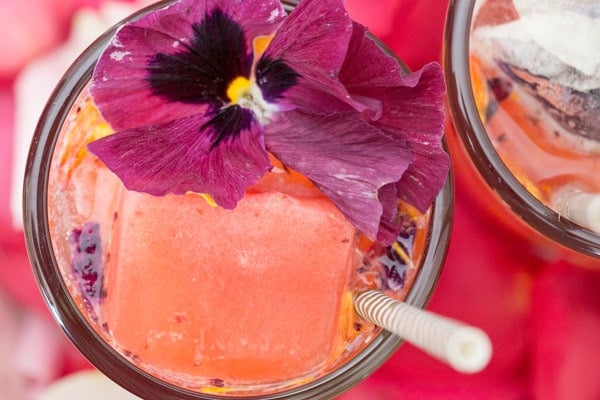 floral cocktail with large pink ice cube
