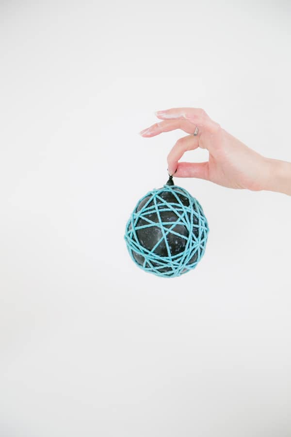 Balloon wrapped in yarn with glue.