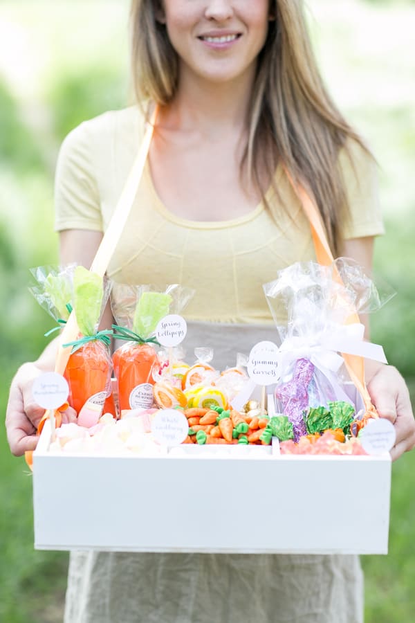 Girl holding an old-fashioned candy box filled with Easter candy - easter bunny