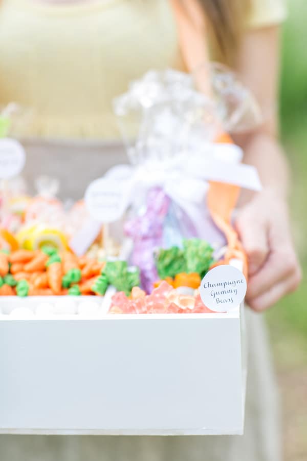 Girl holding a white box filled with candy - easter baskets