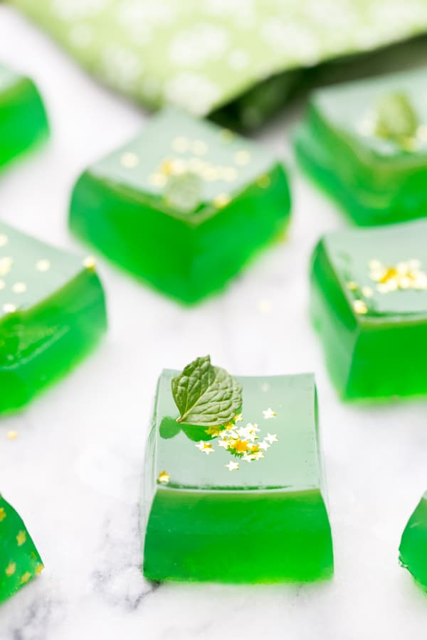 Green Irish Whiskey Jello Shots with mint and edible gold stars.