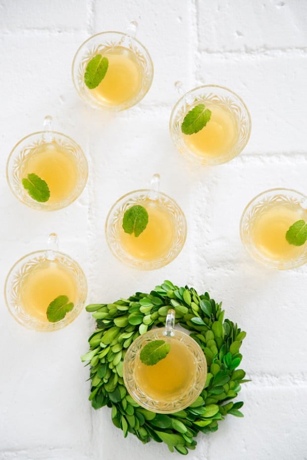 top down shot of tea cocktail in glasses with mint leaf.