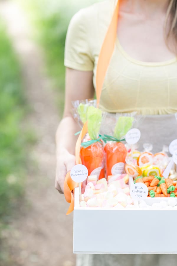 Eden Passante holding a white box filled with spring candy.