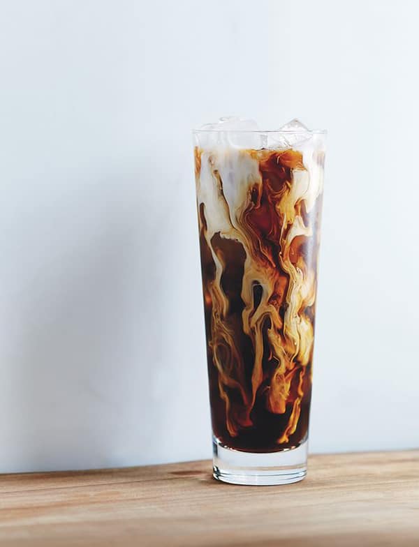 Dublin Iced Coffee with cream being poured into it. 