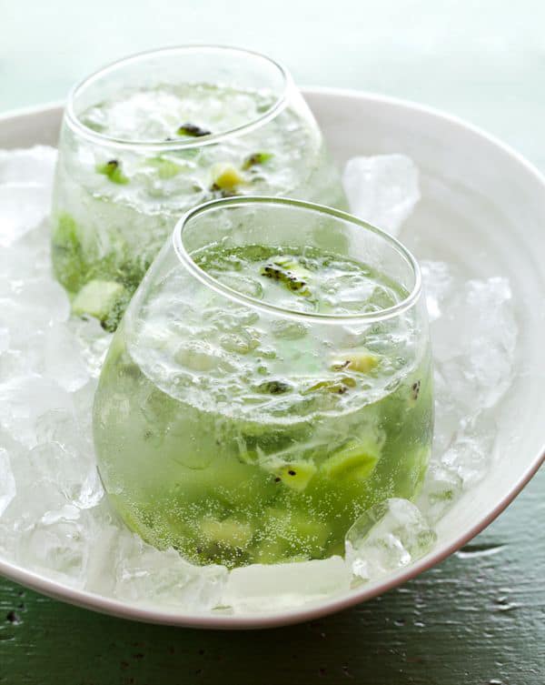 kiwi capiroska over ice in a white bowl.