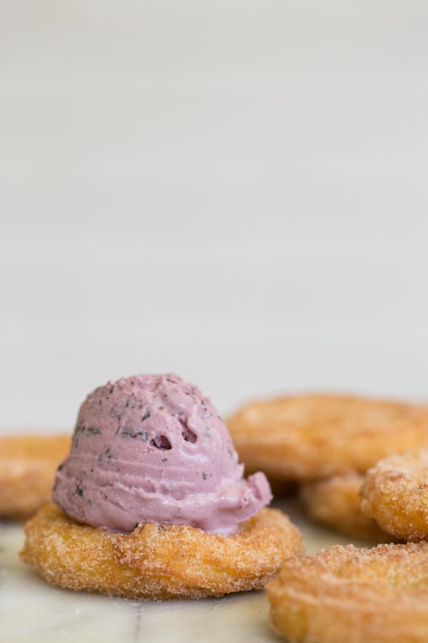 Churros with a scoop of ice cream on top.