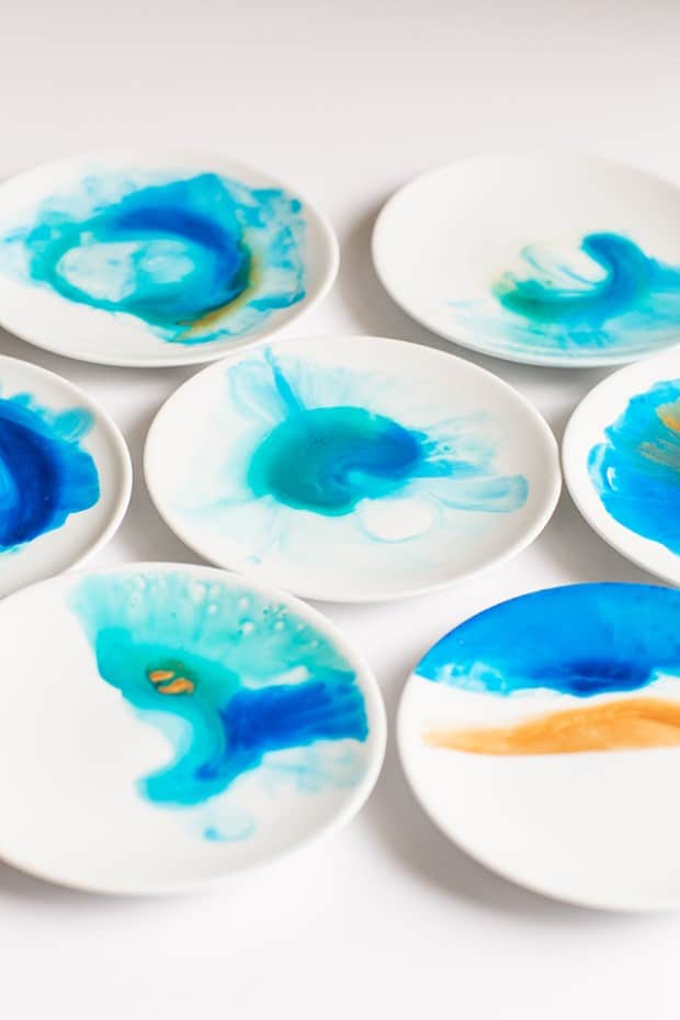 Watercolor plates with blue and turquoise paints.