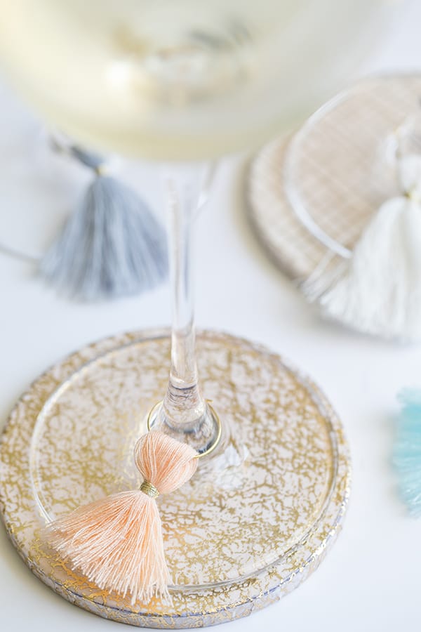 Wine charms on wine glasses on a coaster