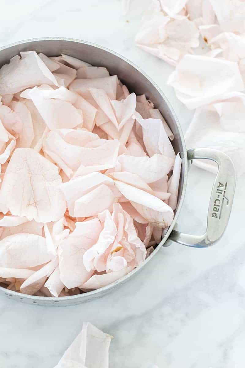 Rose petals in a All-Clad pot. - fresh petals