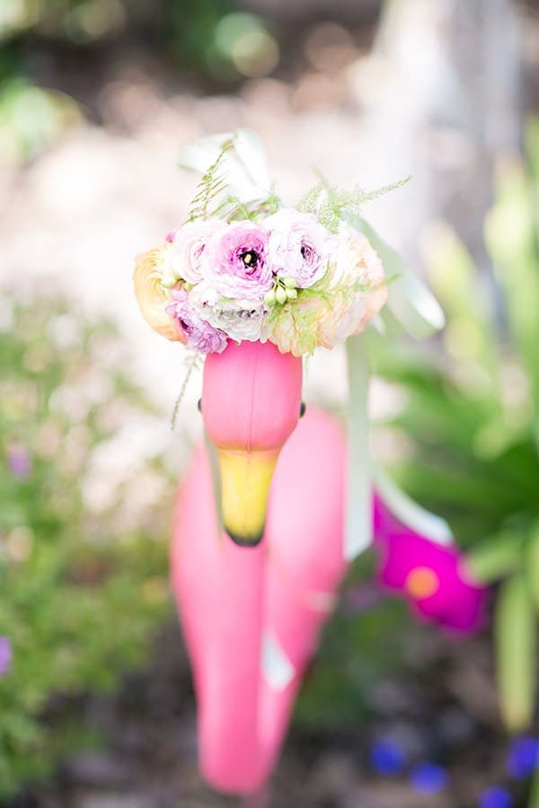 Yard flamingo with a floral head piece 