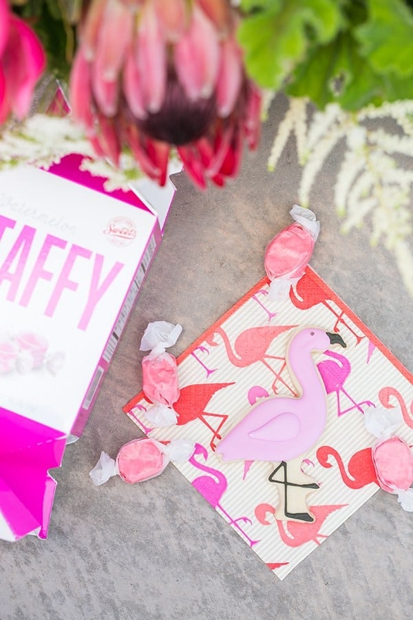 flamingo pool party desserts and napkin, taffy and a flamingo sugar cookie