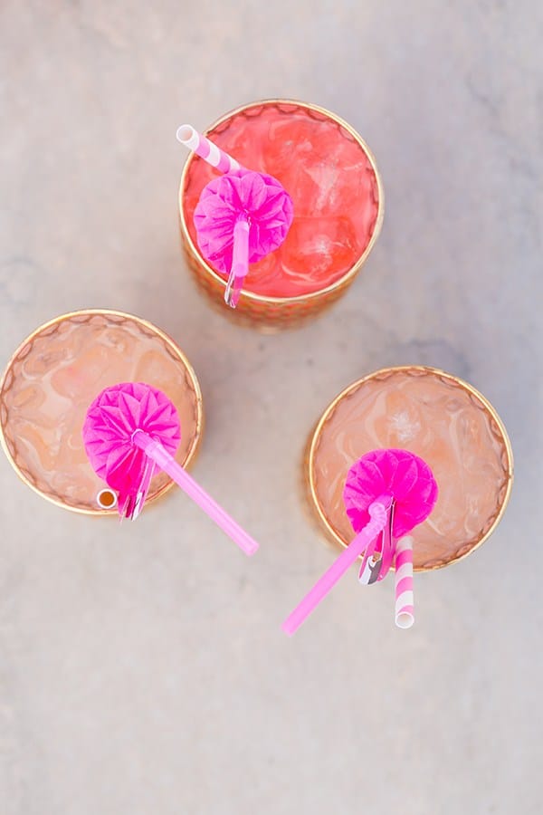 three cocktails with flamingo straws 