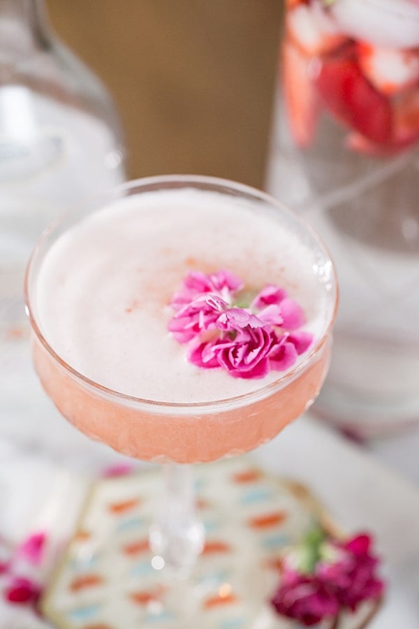 close up shot of gin cocktail with flower