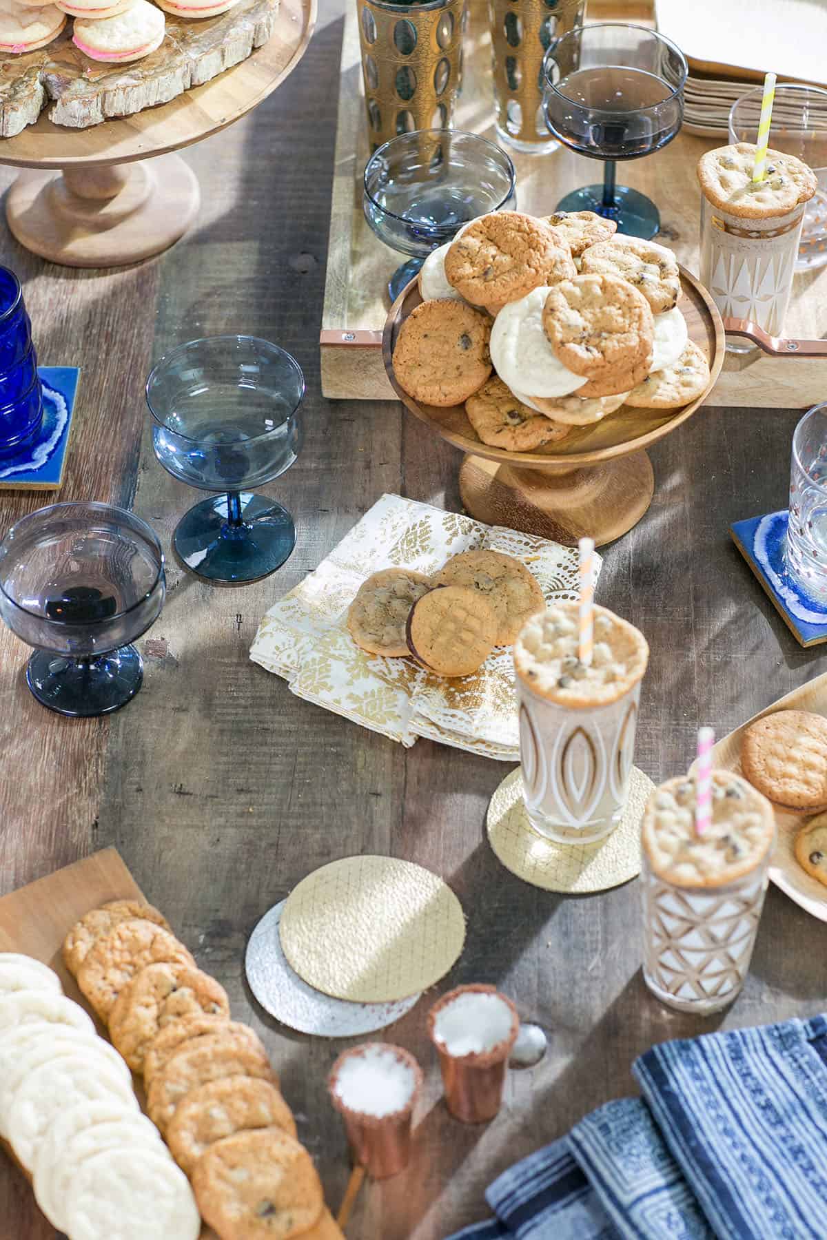 table filled with cookies and cocktails