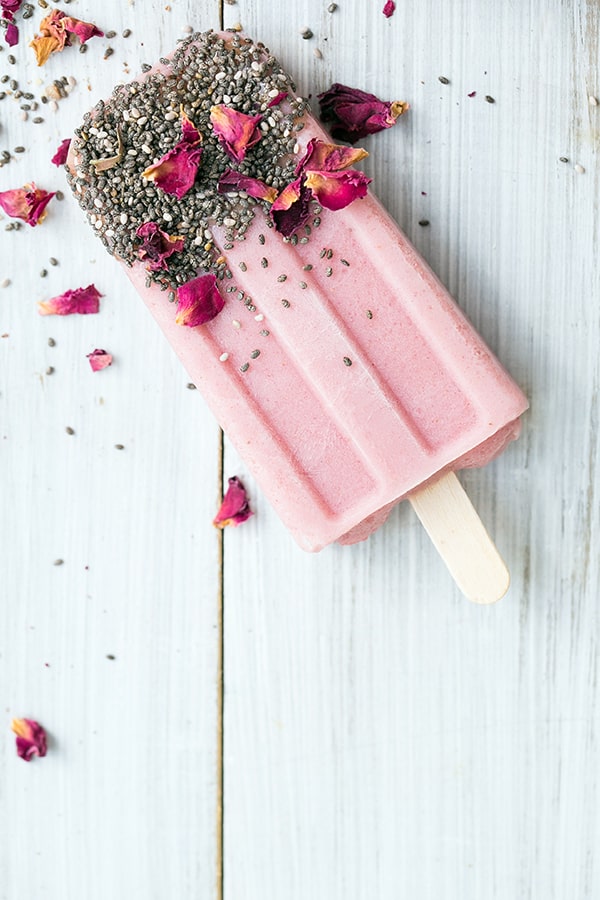 Strawberry banana smoothie with chia seeds and dried rose petals.
